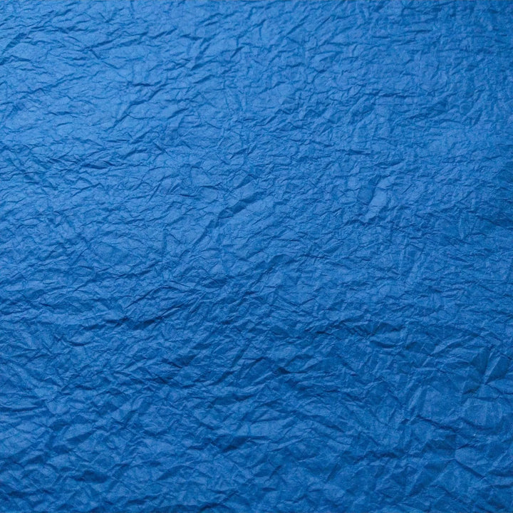 Handmade blue Momigami paper made from mulberry fibers, showcasing a unique texture perfect for bookbinding and decorative arts from Kozo Studio.