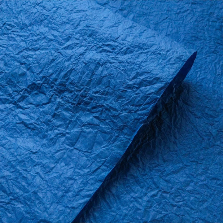 Blue Momigami mulberry paper with crumpled texture from Kozo Studio, ideal for handmade paper crafts and creative projects.
