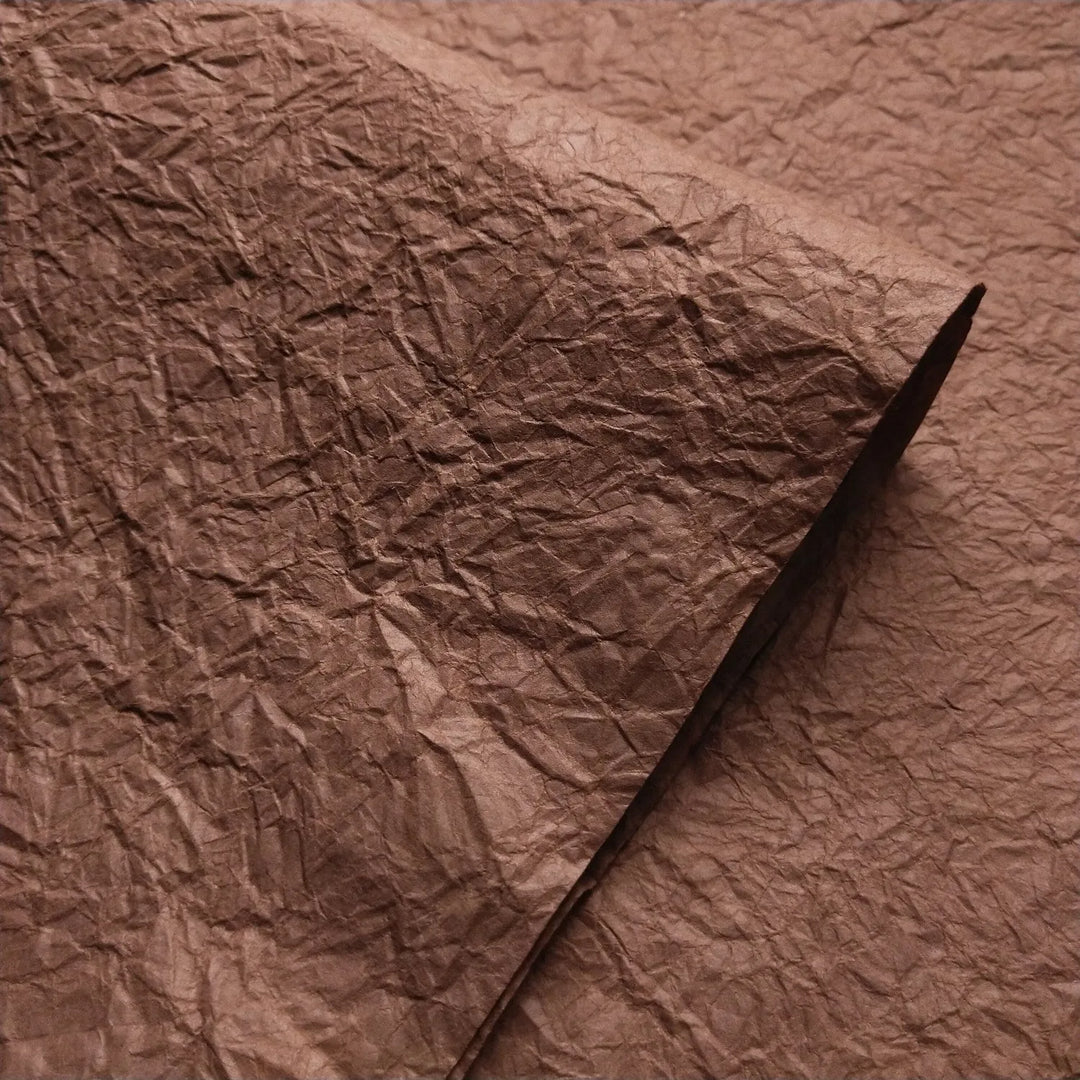 Close-up of Brown Momigami mulberry paper with crumpled texture from Kozo Studio, perfect for handmade paper art and craft projects.