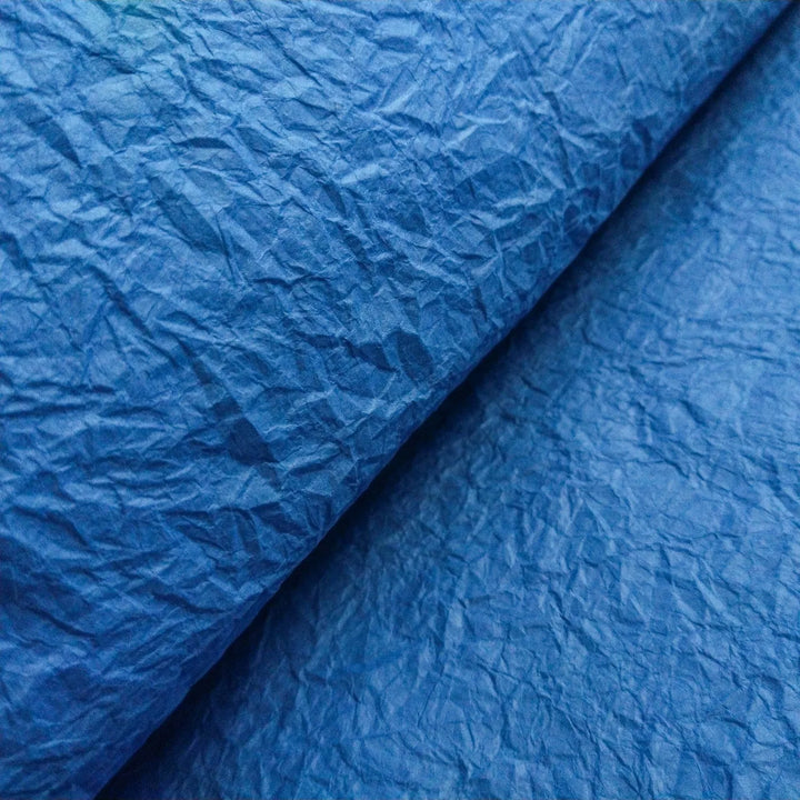 Kozo Studio blue Momigami mulberry paper featuring a crumpled rice paper texture, suitable for various handmade paper applications and crafts.