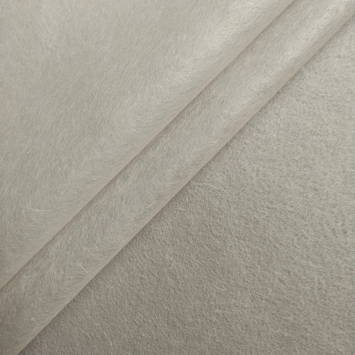 Close-up of Conservator No.1 by Kozo Studio (8.5 gsm; 15 sheets/pack): overlapping sheets of light grey, soft textured felt fabric resembling washi paper, with fine fibers and a slightly fuzzy surface.