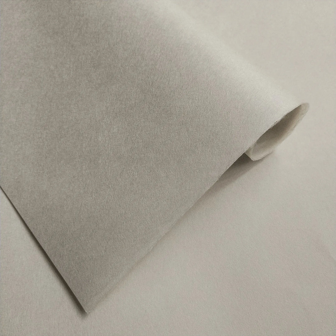Fine-textured handmade paper by Kozo Studio, Conservator No.2 in natural gray, made from kozo pulp and captured under soft lighting to highlight its conservation-grade quality.