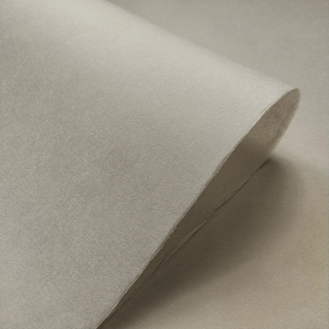 Close-up of Conservator No.2 mulberry paper by Kozo Studio, showing its smooth handmade texture in a soft natural gray tone, ideal for paper conservation.