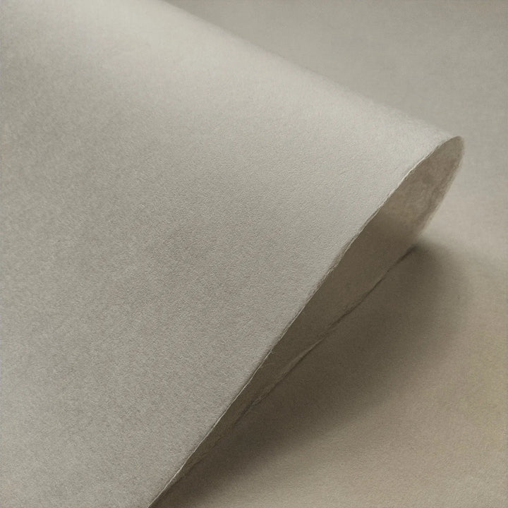 Close-up of Conservator No.2 mulberry paper by Kozo Studio, showing its smooth handmade texture in a soft natural gray tone, ideal for paper conservation.