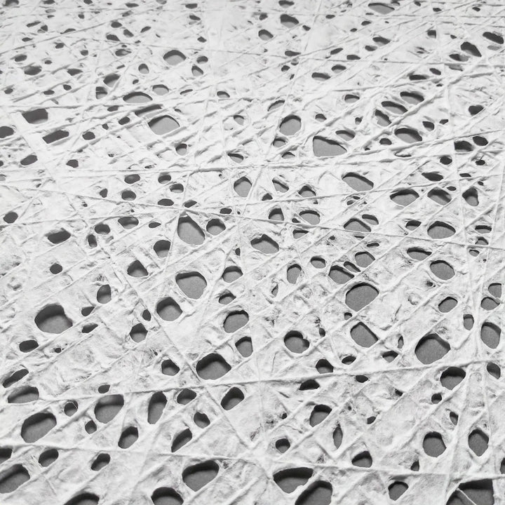 Handmade fishnet paper made from kozo at Kozo Studio, with an elegant mulberry texture and fine cotton thread detailing across the sheet.