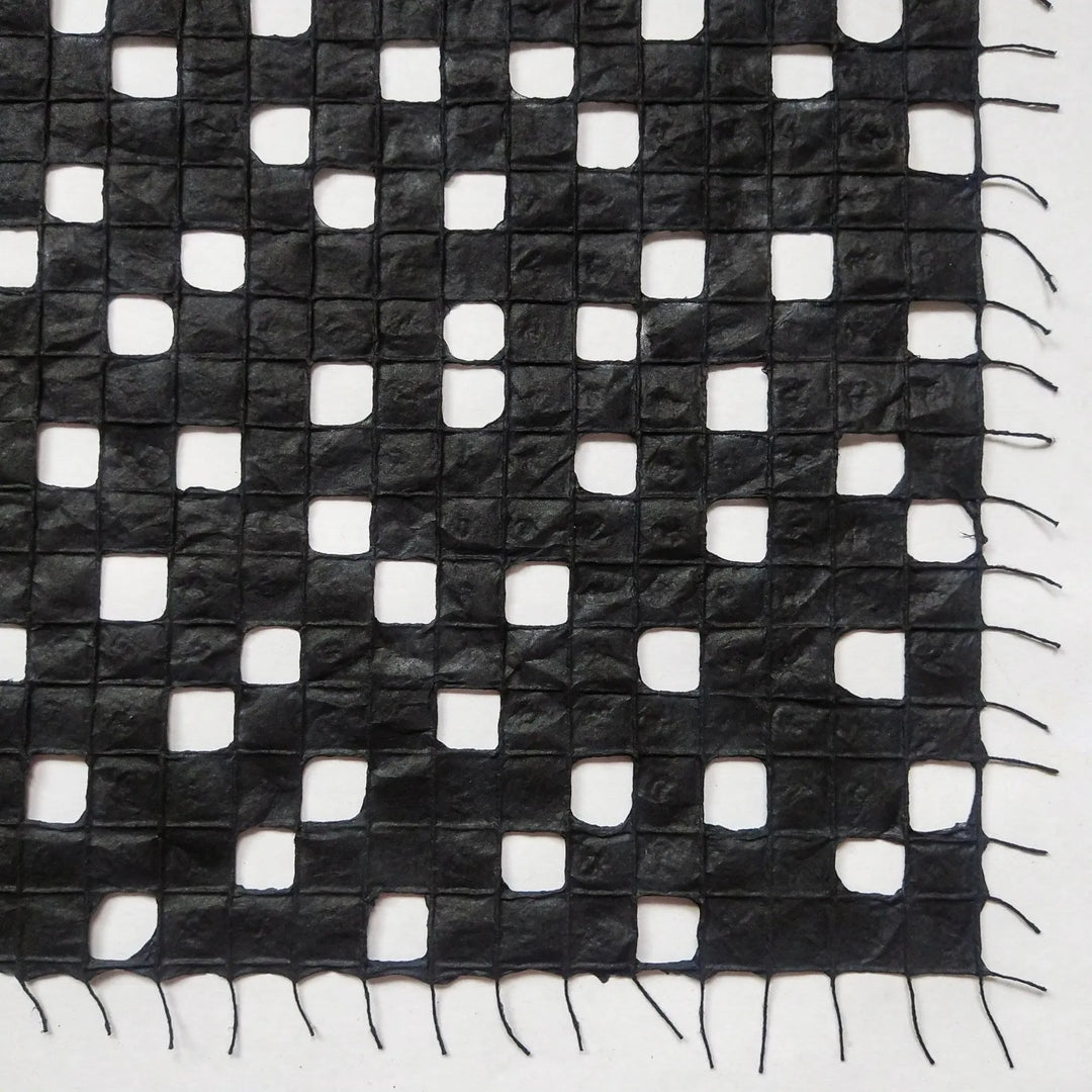 Detailed view of Kozo Studio's handmade paper made from kozo pulp, featuring a subtle and elegant cotton thread pattern.