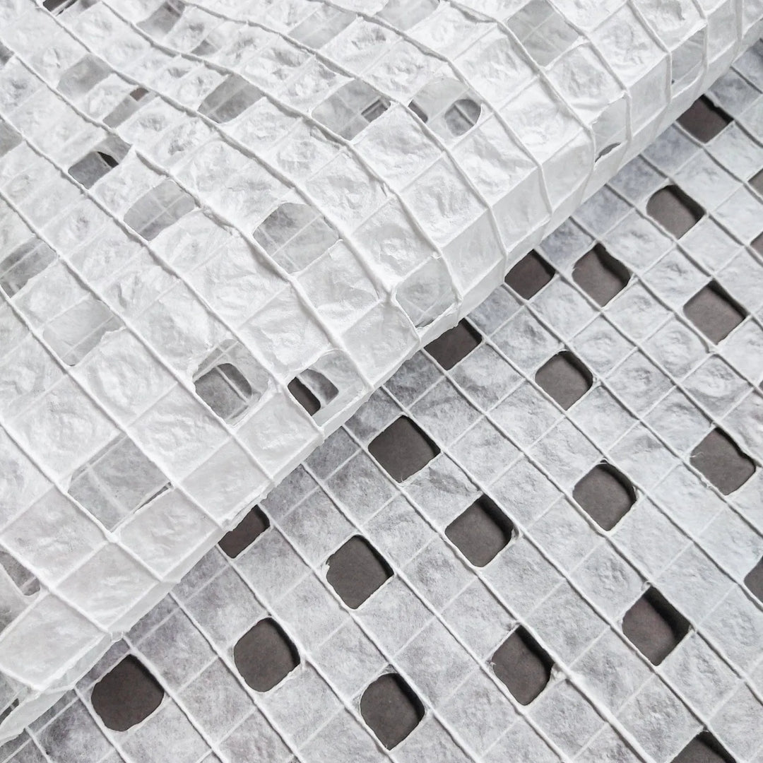 Artisan-crafted white handmade paper made from mulberry fibers at Kozo Studio, showcasing fine cotton threads woven into a checkered design.