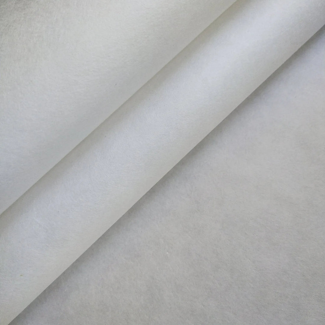 A close-up reveals soft shadows and a minimalist pattern formed by three layers of slightly folded White Kozo Paper (70 gsm, 64x94 cm) from Kozo Studio. The textured material is smooth and semi-translucent.