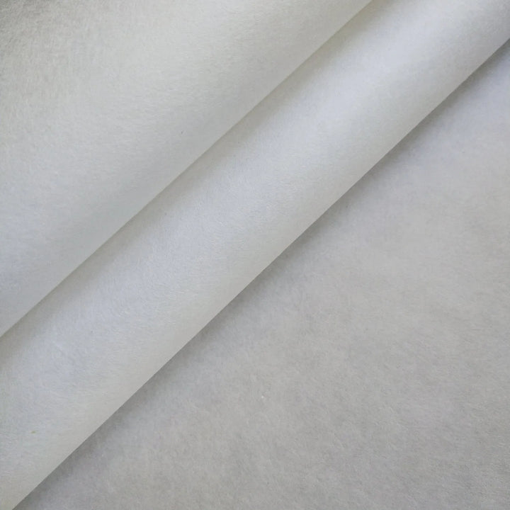A close-up reveals soft shadows and a minimalist pattern formed by three layers of slightly folded White Kozo Paper (70 gsm, 64x94 cm) from Kozo Studio. The textured material is smooth and semi-translucent.