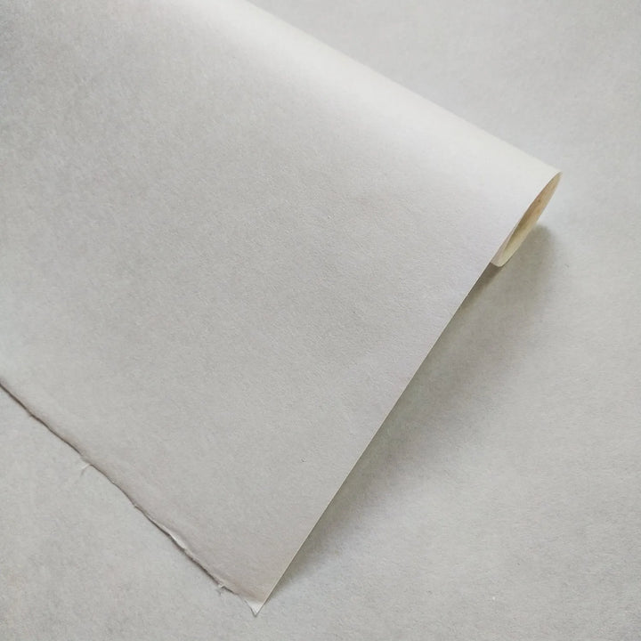 High-resolution image showing a single sheet of Kozo Studio white handmade paper made from mulberry fibers, perfect for woodblock printing, calligraphy, and crafts.