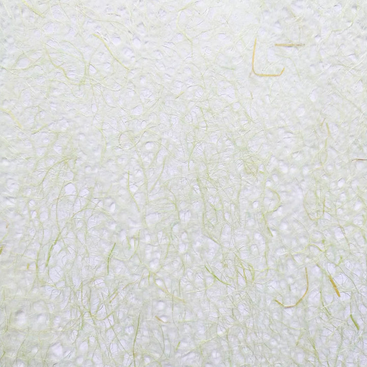 Close-up of Asarakusui Lace Paper by Kozo Studio, showcasing a textured surface reminiscent of rice paper, with subtle, random patterns of thin, wispy light green fibers interwoven throughout for a delicate and airy appearance.