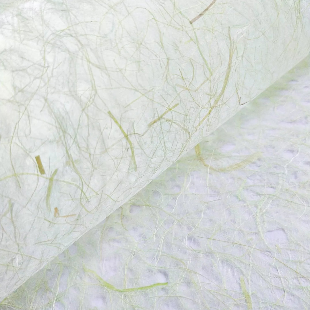 A close-up of Kozo Studios Asarakusui Lace Paper in Light Green showcases its translucent texture with thin, fibrous strands and visible fibers in light green and beige, offering a natural, organic appearance.