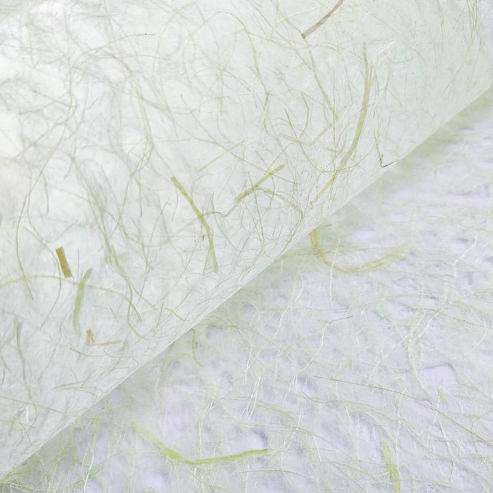 A close-up of Kozo Studios Asarakusui Lace Paper in Light Green showcases its translucent texture with thin, fibrous strands and visible fibers in light green and beige, offering a natural, organic appearance.