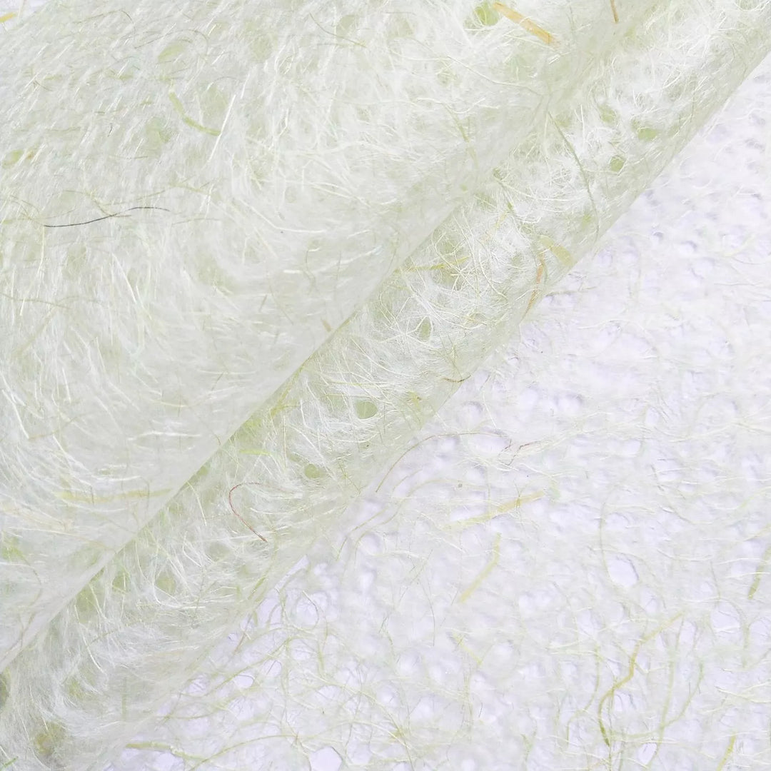 Translucent handmade paper from Kozo Studio in light green, showcasing the intricate fibers and natural texture of high-quality mulberry paper.