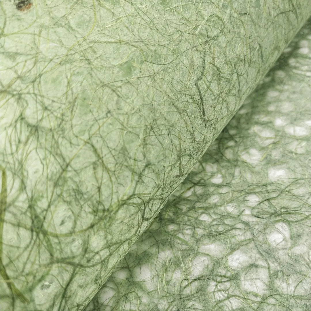 Close-up of Kozo Studio handmade paper showcasing Asarakusui Lace Paper in Moss with intricate green fibers and natural mulberry texture.