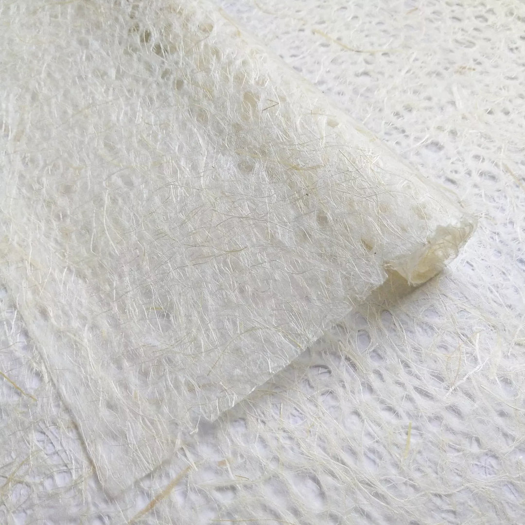 Natural Asarakusui lace paper roll from Kozo Studio, made with kozo and Manila hemp fibers, featuring the signature handmade paper look.