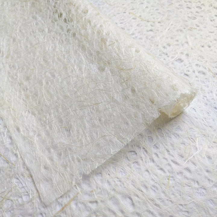 Natural Asarakusui lace paper roll from Kozo Studio, made with kozo and Manila hemp fibers, featuring the signature handmade paper look.