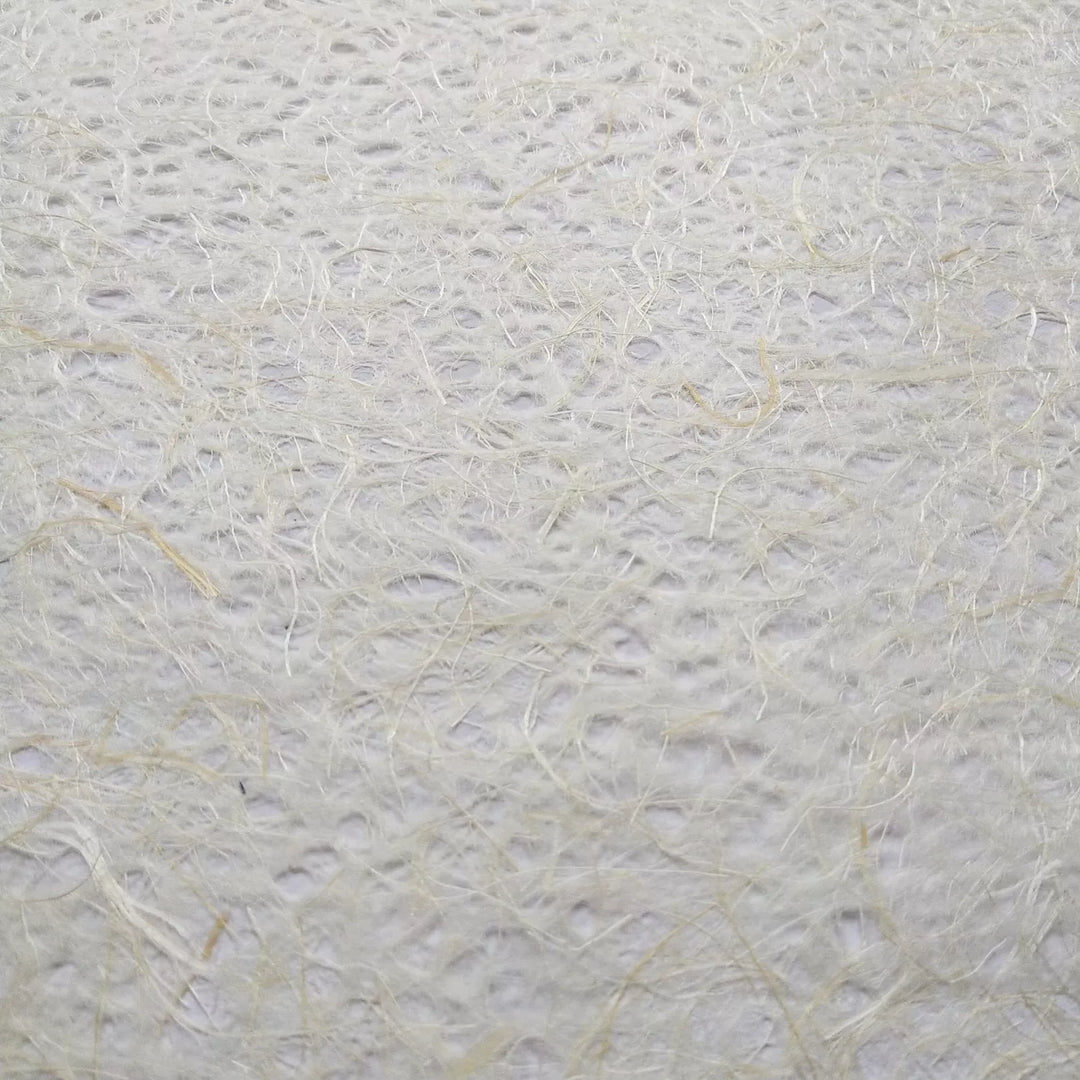 Rolled sheet of natural Asarakusui lace paper made from mulberry and abaca fiber at Kozo Studio, highlighting its artisanal handmade design.