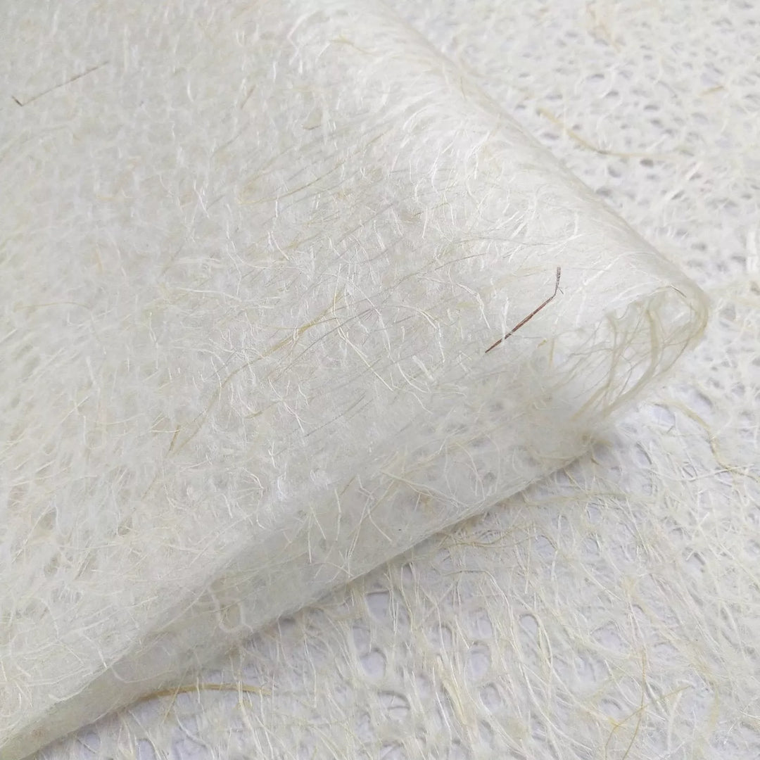 Detail of Kozo Studio mulberry paper crafted using the Rakusui method, with visible fiber strands and delicate handmade paper texture.