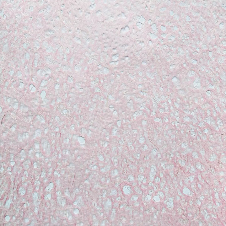 Handmade mulberry paper by Kozo Studio featuring Asarakusui Lace design in pink with visible fibers and delicate brown thread patterns.