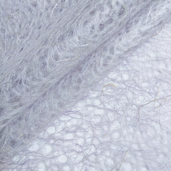 Intricate purple mulberry paper crafted by Kozo Studio, featuring a lace-like pattern and organic handmade paper texture.