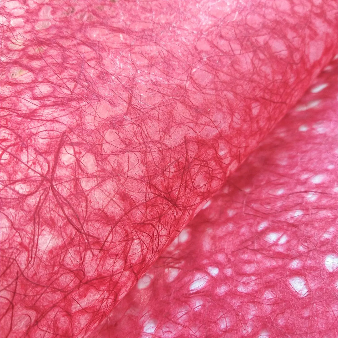 Close-up of vibrant red Asarakusui mulberry paper by Kozo Studio, highlighting the intricate web-like texture and semi-translucent handmade design.