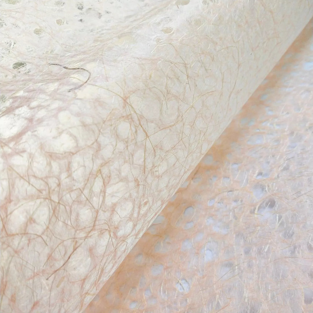Close-up of Asarakusui Lace Paper in Old Rose by Kozo Studio, showcasing delicate handmade paper with fibrous patterns and a soft mulberry texture.