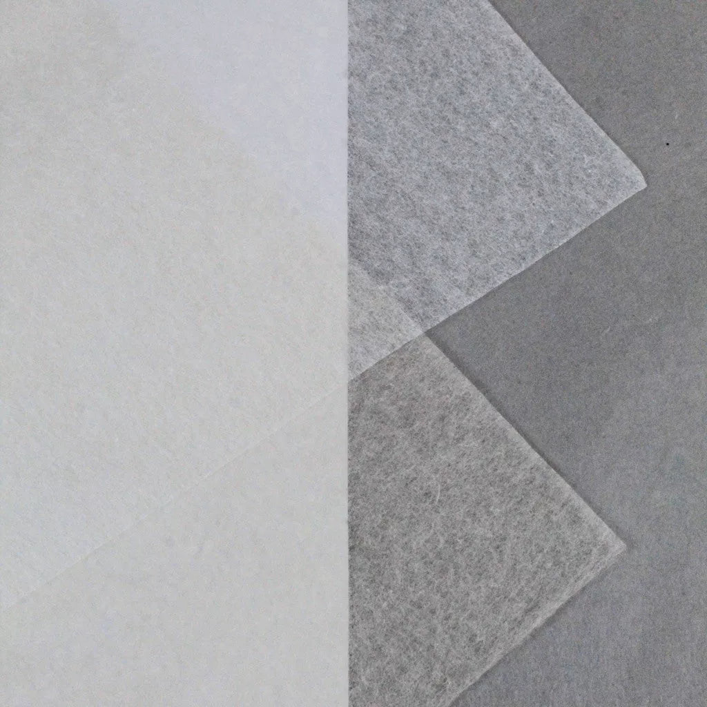 Three overlapping sheets of Kozo Studio’s Conservator No.1 washi paper (8.5 gsm) are displayed on a gray background—one angled, two vertical—highlighting the delicate, layered quality of this 15-sheet pack crafted from kozo pulp.