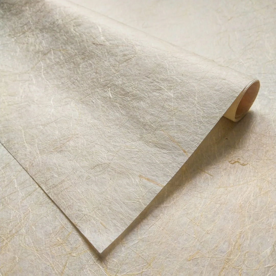 Semi-translucent handmade paper by Kozo Studio, showcasing Kinwashi mulberry paper with a durable, textured surface ideal for creative work such as crafting and bookbinding.