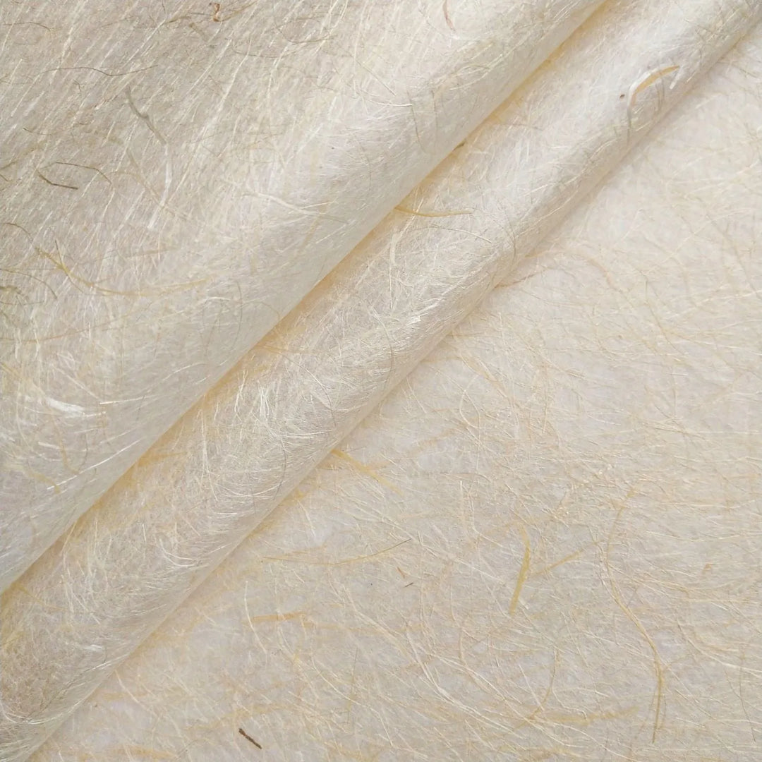 Close-up of Kinwashi mulberry paper handcrafted at Kozo Studio, showing its golden hue, textured surface, and semi-translucent quality ideal for bookbinding and lampshades.