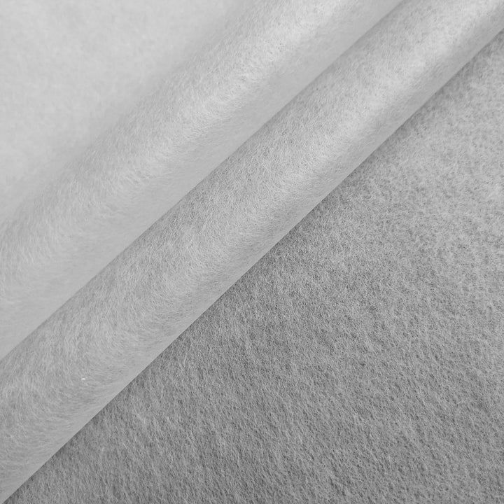 Close-up of overlapping Conservator No.1 sheets (8.5 gsm, 15/pack) by Kozo Studio, resembling washi paper or textured felt with soft shadows and layers—evoking traditional kozo pulp craftsmanship.