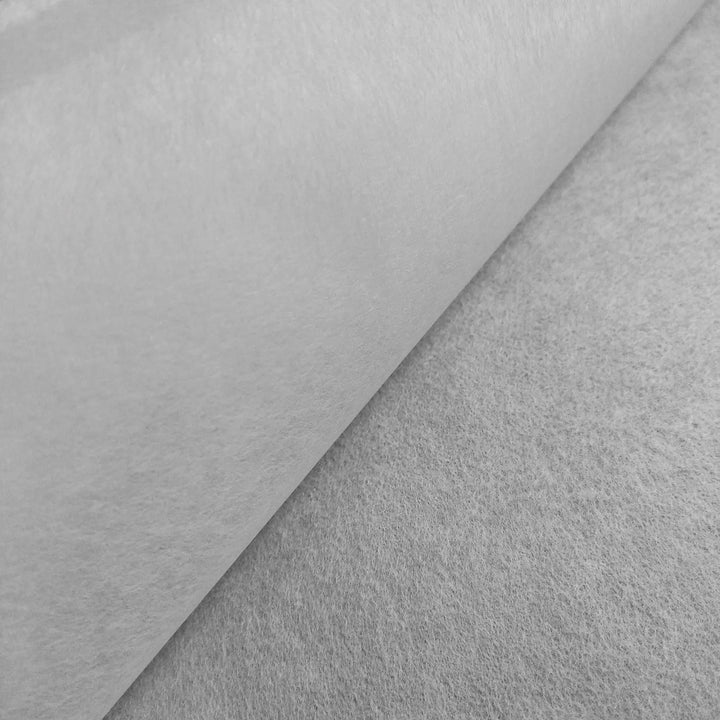 A close-up, angled view of Kozo Studio’s Conservator No.1 washi paper (8.5 gsm; 15 sheets/pack) partially rolled out on a textured, light-colored surface.