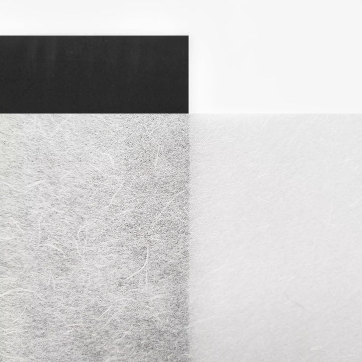 A minimalist image inspired by Kozo Studio’s A4 Decoupage Unryu Mulberry Paper (40 Sheets, 30 gsm) features a textured black and white split with a soft gradient line and a solid black rectangle at the top left on white.