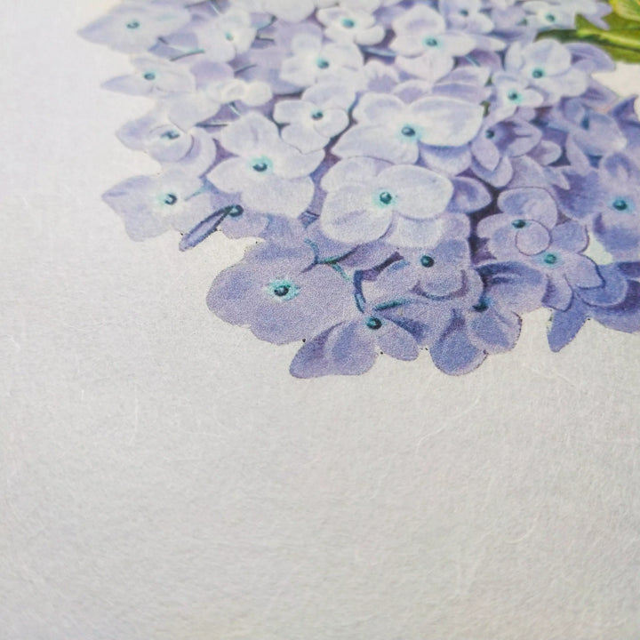 A close-up of a cluster of light purple hydrangea flowers with green centers, printed on Kozo Studio A4 Decoupage Unryu Mulberry Paper (40 Sheets, 30 gsm), featuring a textured surface for enhanced ink absorption.