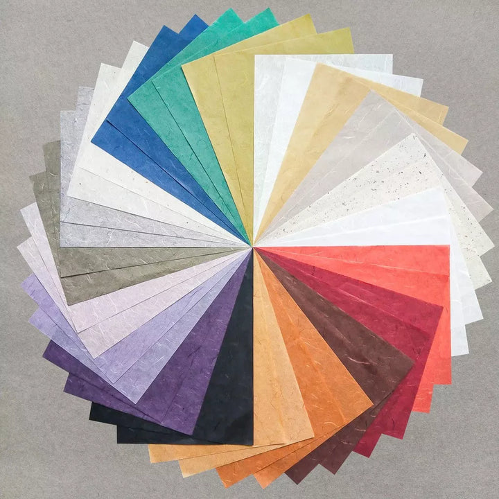 Kozo Studios Assorted A4 Earth Unryu Kozo Paper Set features 40 textured mulberry sheets in blue, green, yellow, white, orange, red, purple, and brown swatches arranged fan-like on a gray background.