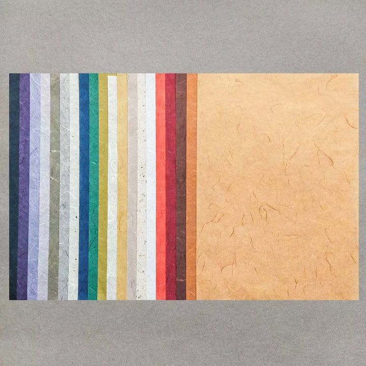 The Kozo Studio Assorted A4 Earth Unryu Kozo Paper Set (40 Sheets) showcases textured mulberry paper strips in vibrant colors like blue, green, yellow, and red.