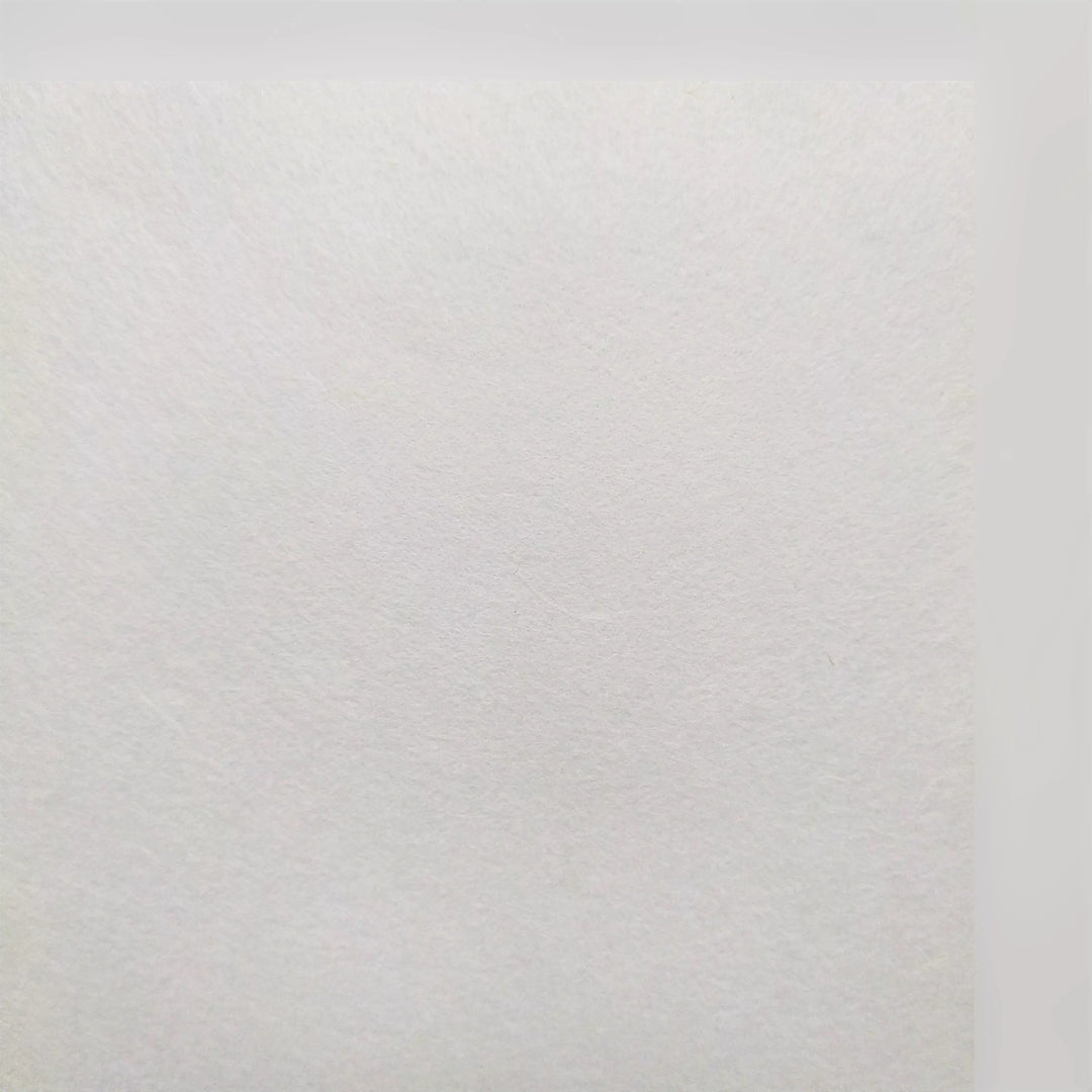 A close-up of A4 Extra Thin White Kozo Paper by Kozo Studio, showcasing its slightly rough texture and subtle visible fibers. Uniform lighting highlights the intricate details typical of this 25 gsm mulberry paper.