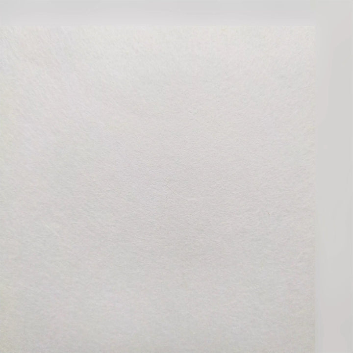 A close-up of A4 Extra Thin White Kozo Paper by Kozo Studio, showcasing its slightly rough texture and subtle visible fibers. Uniform lighting highlights the intricate details typical of this 25 gsm mulberry paper.