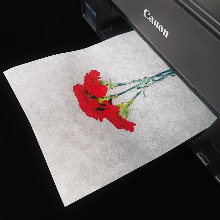 A sheet of Kozo Studio’s A4 Decoupage Plain Mulberry Paper (30 gsm) featuring red carnations prints beautifully from a Canon printer against a black background, highlighting excellent ink absorption.