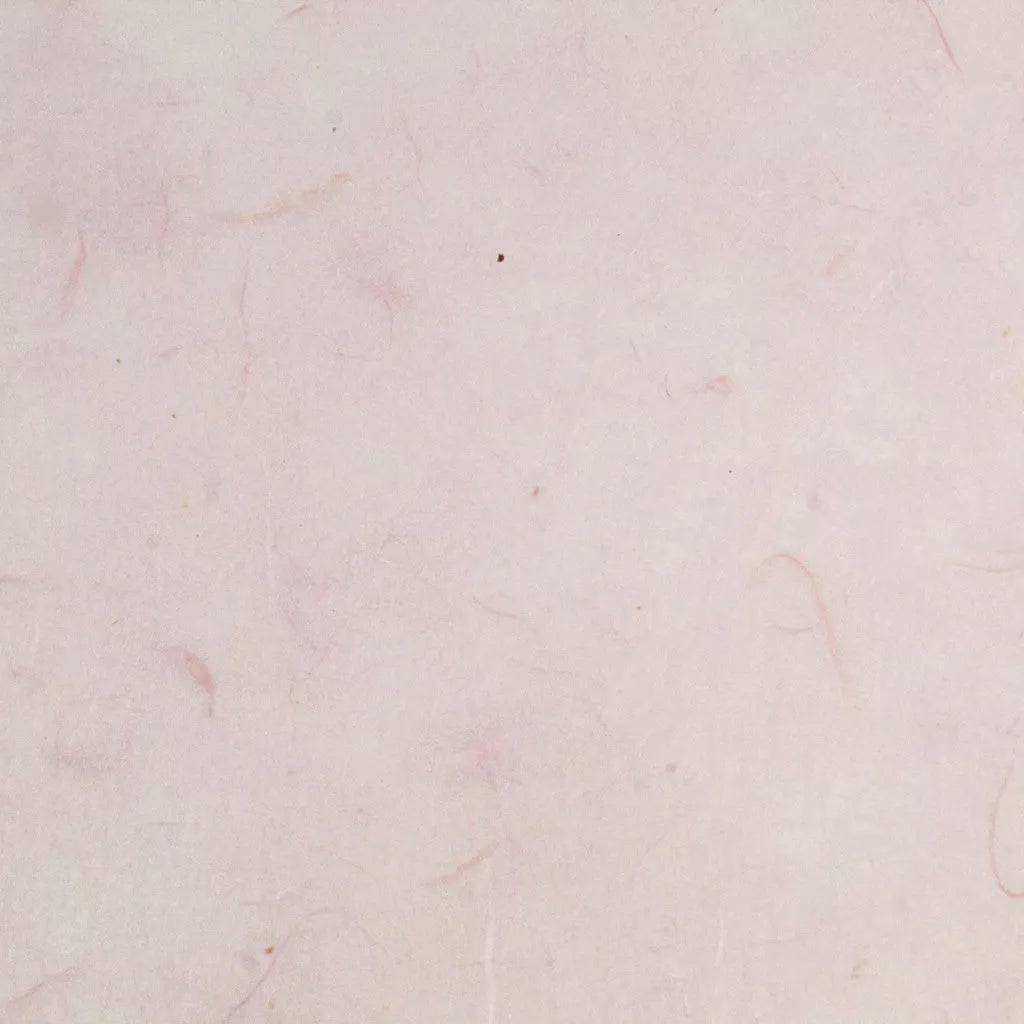 The Water-resistant Kozo Paper (Pink) by Kozo Studio features a textured surface with a soft pink hue of mulberry paper, along with faint, natural patterns and lines that enhance its delicate and minimalist look.