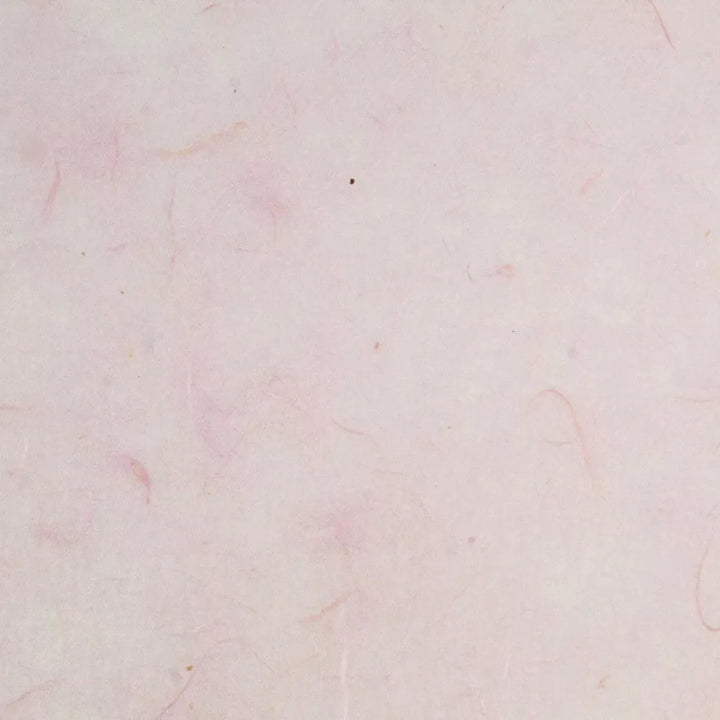 The Water-resistant Kozo Paper (Pink) by Kozo Studio features a textured surface with a soft pink hue of mulberry paper, along with faint, natural patterns and lines that enhance its delicate and minimalist look.