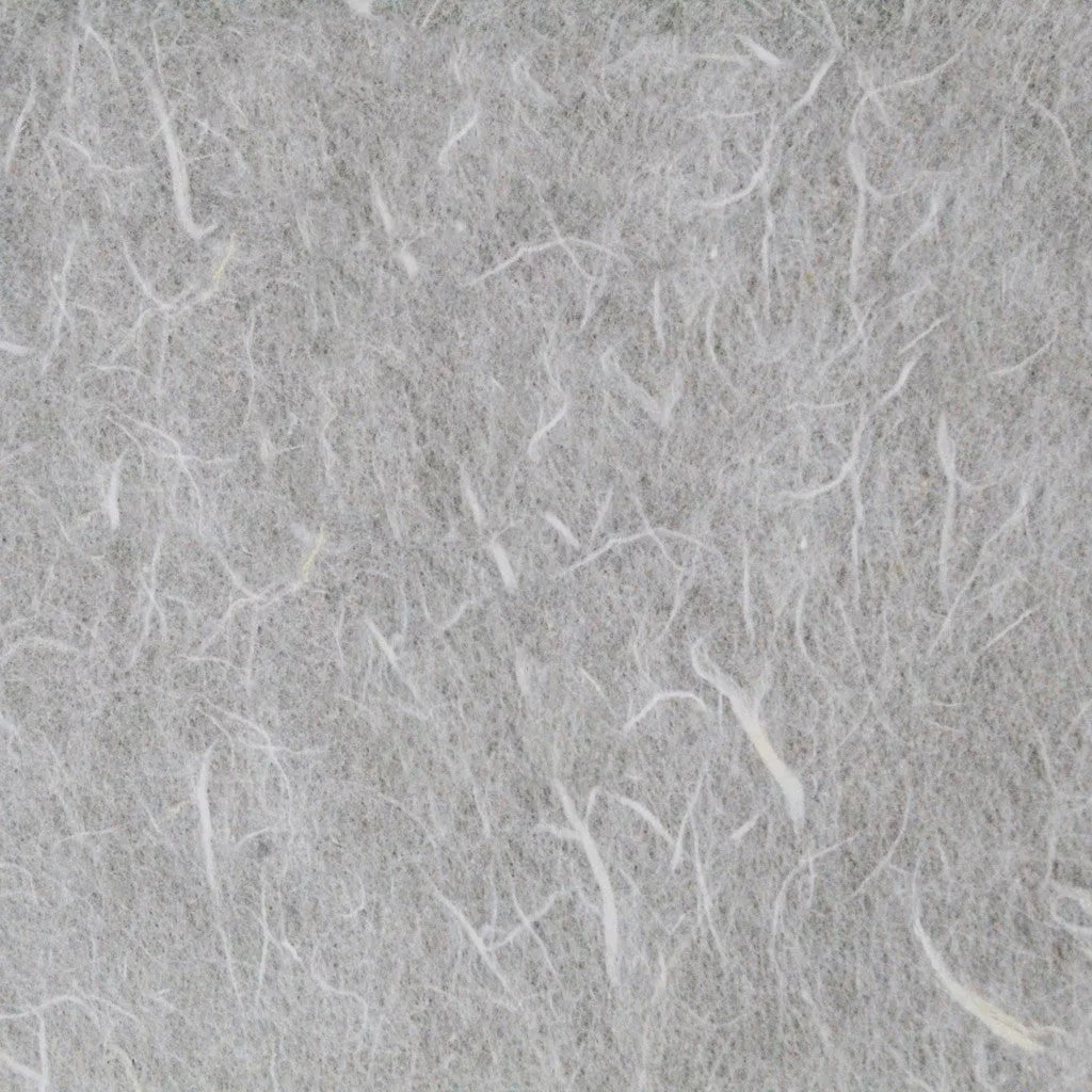 The image highlights a coarse texture reminiscent of felt or wool, with thin white fibers intricately woven. It evokes the delicate weave of mulberry paper, akin to Kozo Studios Water-resistant Kozo Paper (White), creating a soft and fibrous appearance.