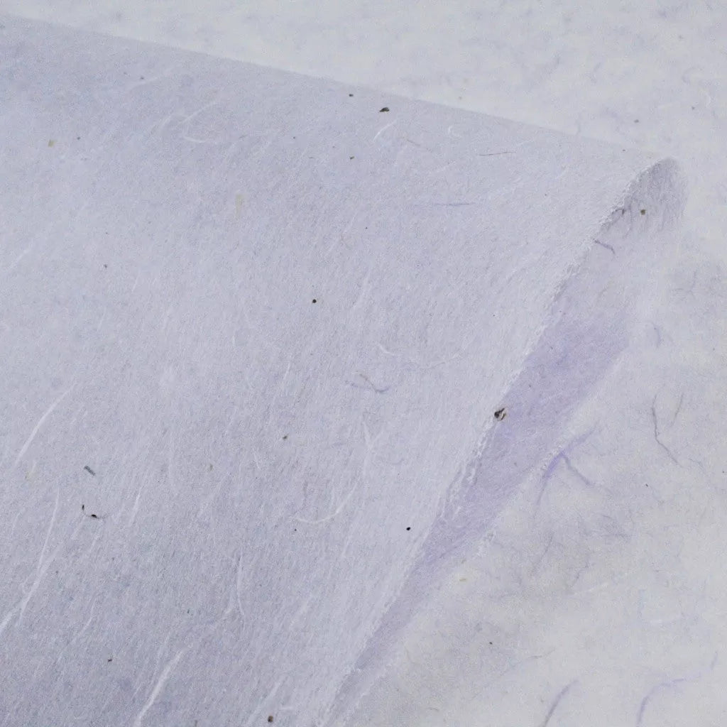 Close-up of water-resistant Kozo Paper (Lavender) by Kozo Studio, featuring visible fibers and a light color. The paper is slightly curled at the corner, showcasing its thickness and natural imperfections.