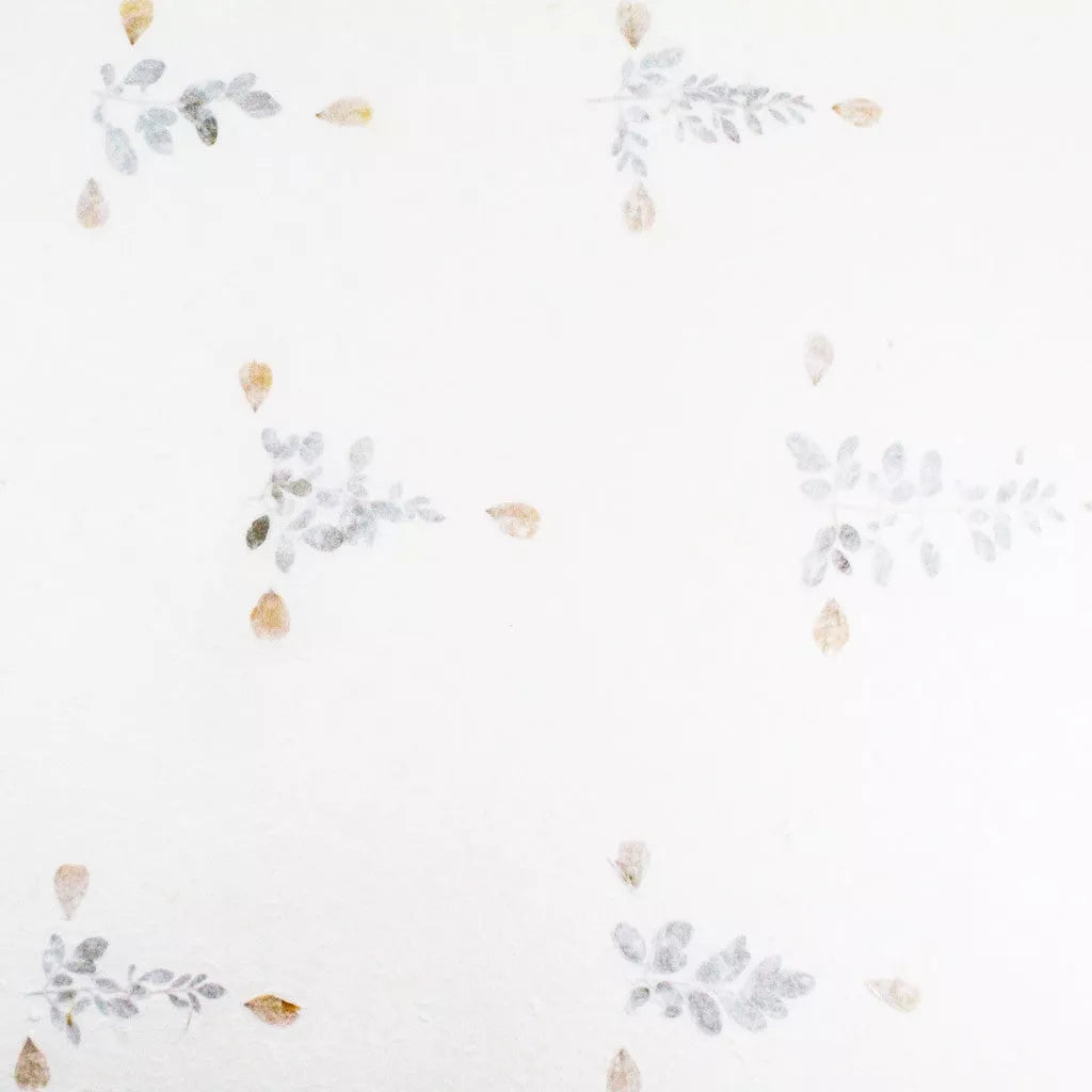 Floral handmade paper from Kozo Studio made with white mulberry paper and pressed dried flowers, offering a whimsical and natural look.