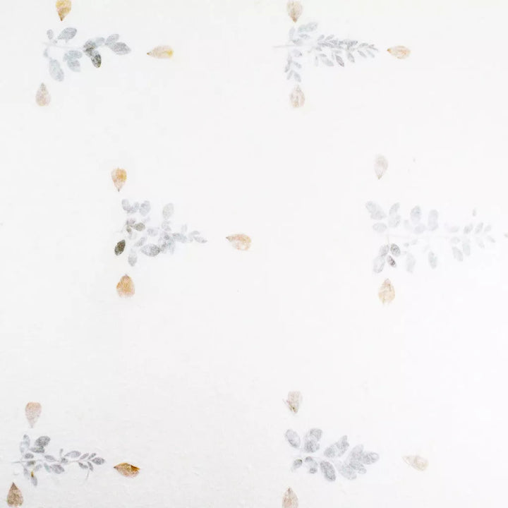 Floral handmade paper from Kozo Studio made with white mulberry paper and pressed dried flowers, offering a whimsical and natural look.