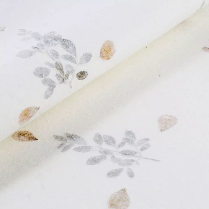 Kozo Studio close-up showing handmade mulberry paper with dried flower inclusions, great for artistic and vintage-inspired paper creations.