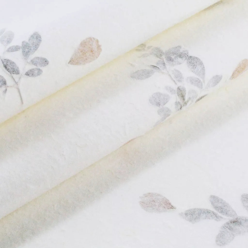 Handmade mulberry paper from Kozo Studio with delicate floral inclusions, ideal for invitations, cards, and other elegant paper crafts.