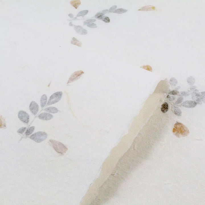 White mulberry paper by Kozo Studio featuring dried flowers, a handmade paper design perfect for rustic cards and elegant DIY stationery.