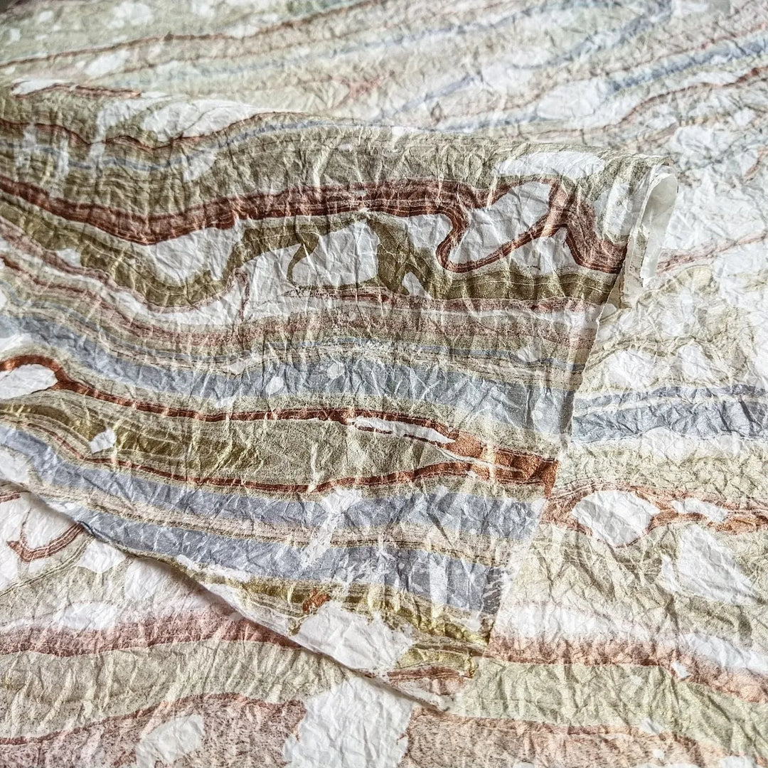 Detailed image of Milano Kozo handmade paper from Kozo Studio, made with mulberry paper and highlighted by elegant marbled patterns and a soft fabric-like finish.