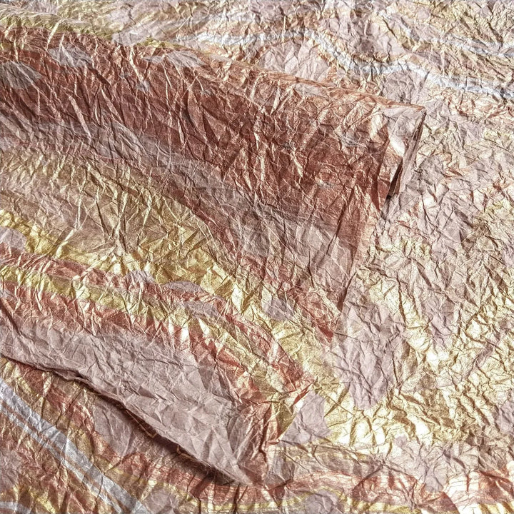 Artistic shot of Kozo Studio's handmade paper Design 11, highlighting the swirling oil hues on mulberry paper with a fabric-like texture in a soft taupe tone.
